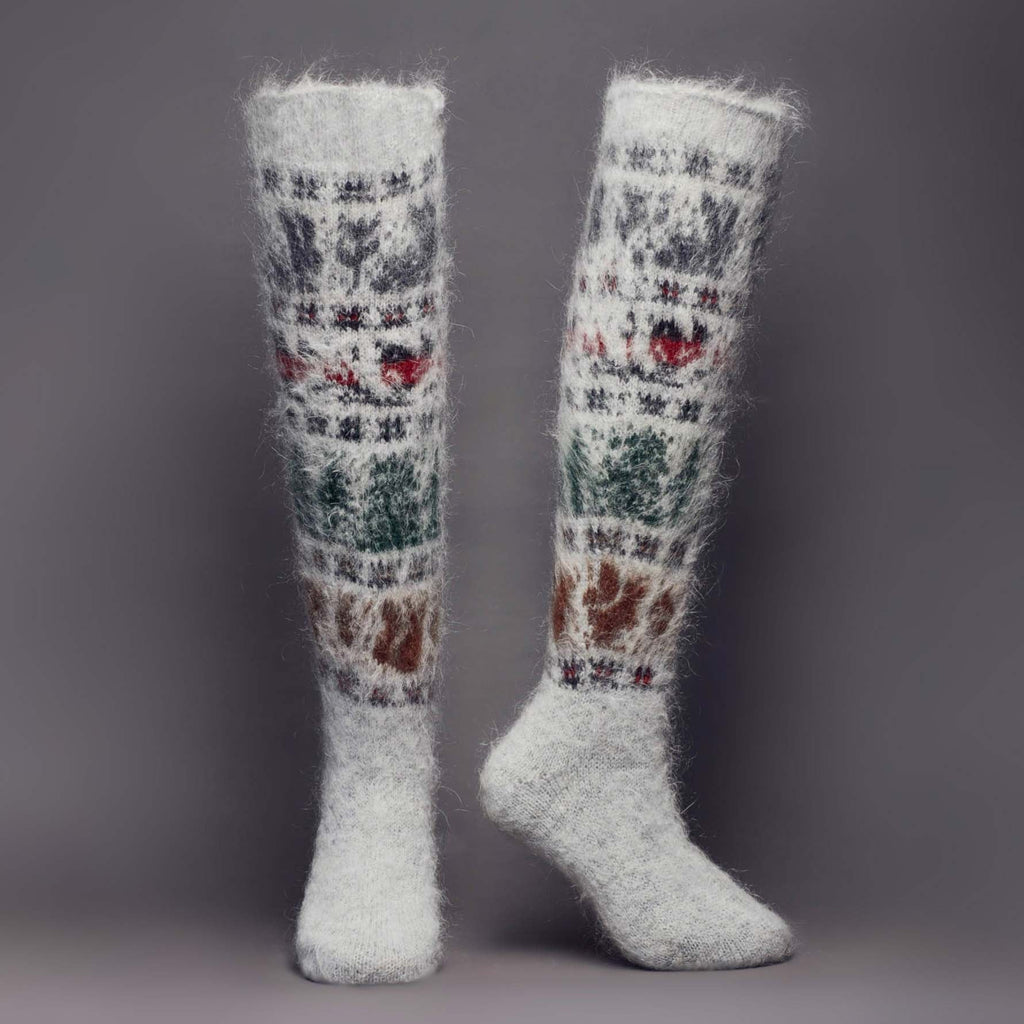 Warm goat hair grey knee-high relaxed-fit socks with bunnies, birds, trees, and squirrels - front view.