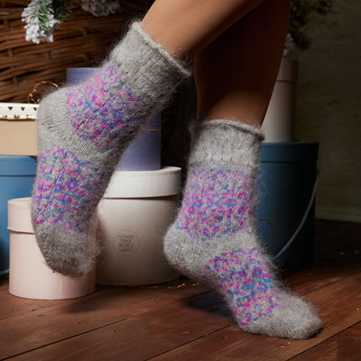 Woman's legs wearing grey goat hair crew sock and multicolor purple design.