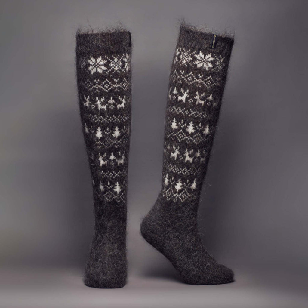 Black goat hair knee-high socks with white snowflake and deer design - front view.