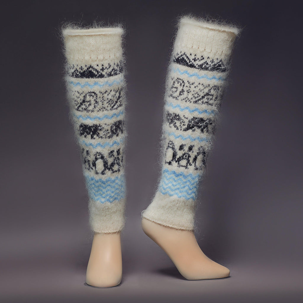 Warm, fuzzy goat hair white and leg warmers with black mountains, owls, bears, and penguins - front view.