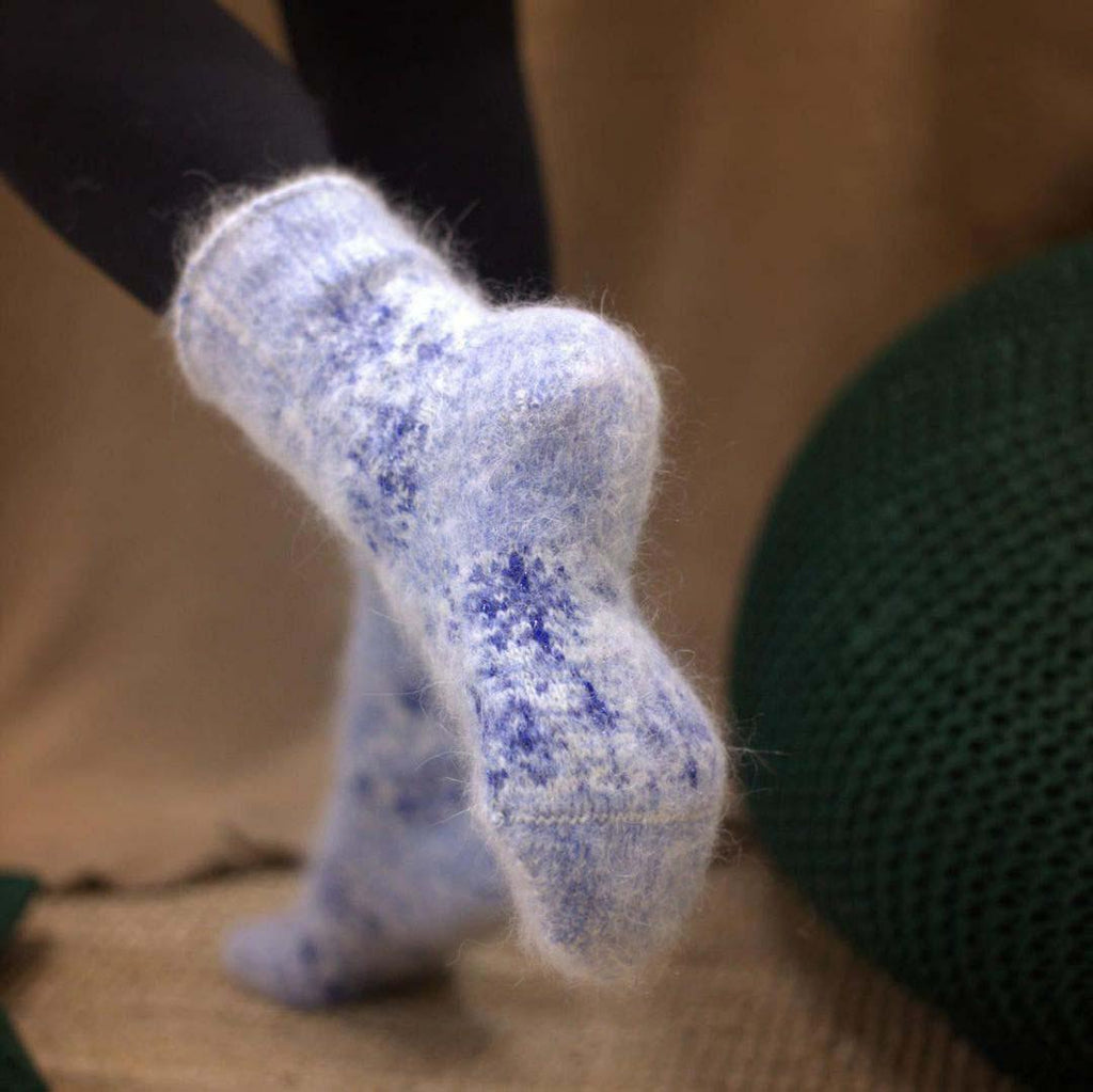 Light blue crew length goat wool socks extra thick with blue snowflake design.