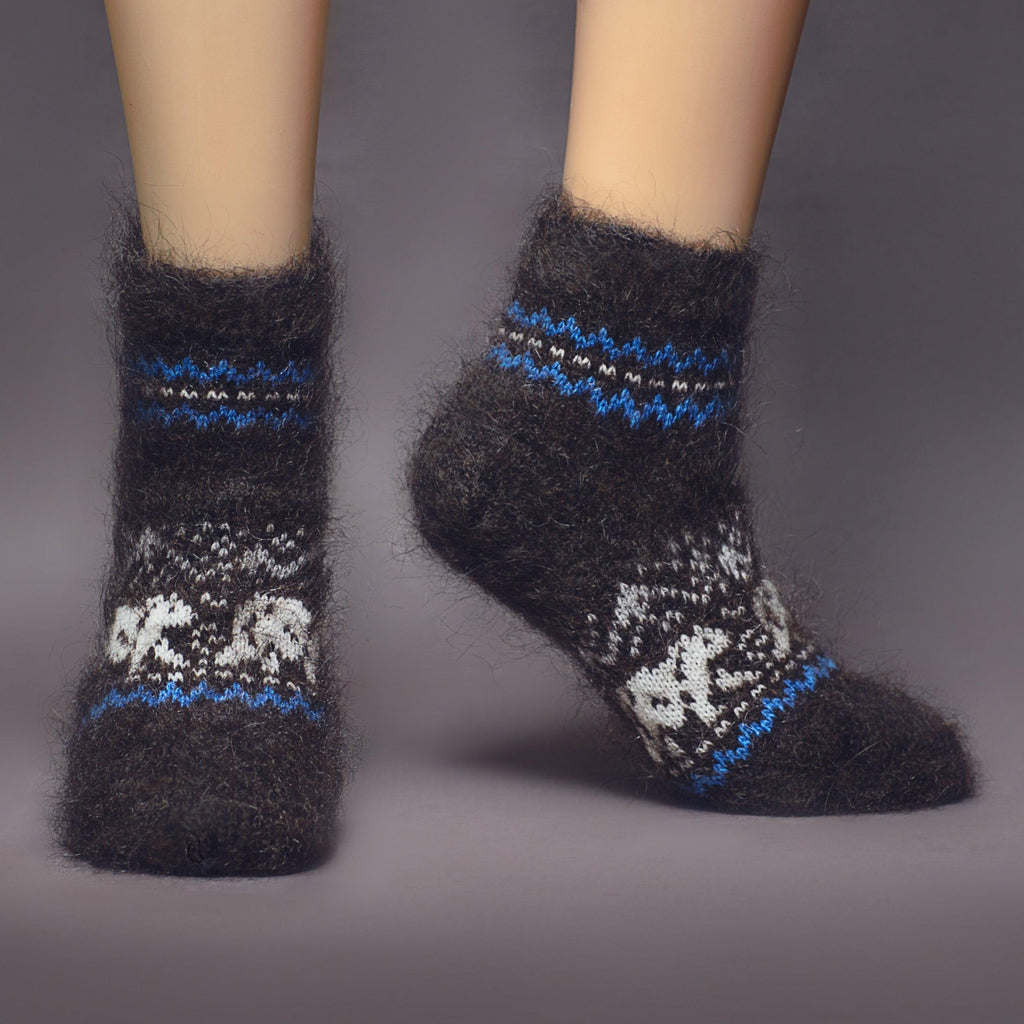 Black low-cut goat hair socks with white and blue polar bear design - front view.