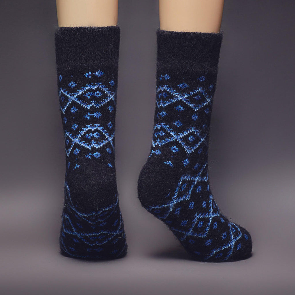 Man's merino wool black winter crew socks with blue diamond-shaped design - back view.