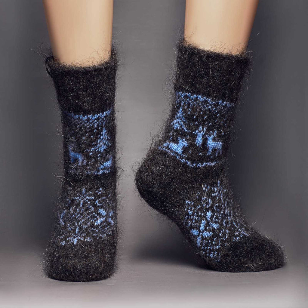 Warm goat hair charcoal crew socks with blue deer, trees, and winter ornaments - front view.