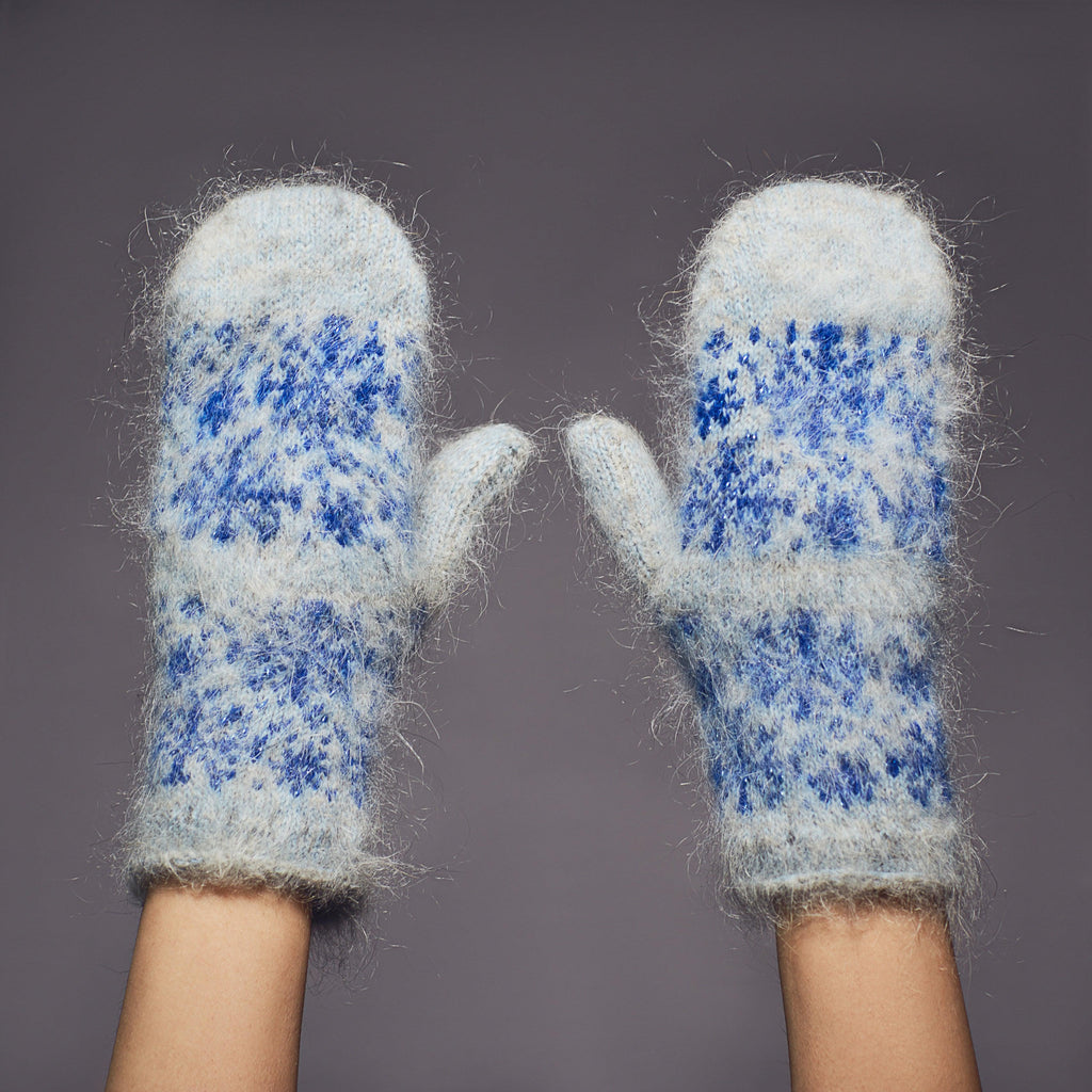 Fuzzy goat hair light blue mittens with blue snowflakes.