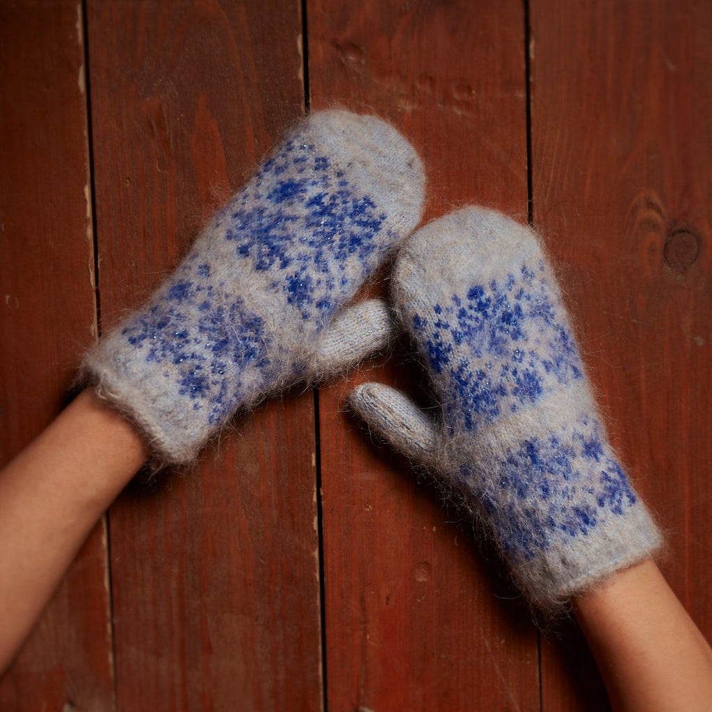 Goat hair warm and fuzzy light blue mittens with a blue snowflake design.