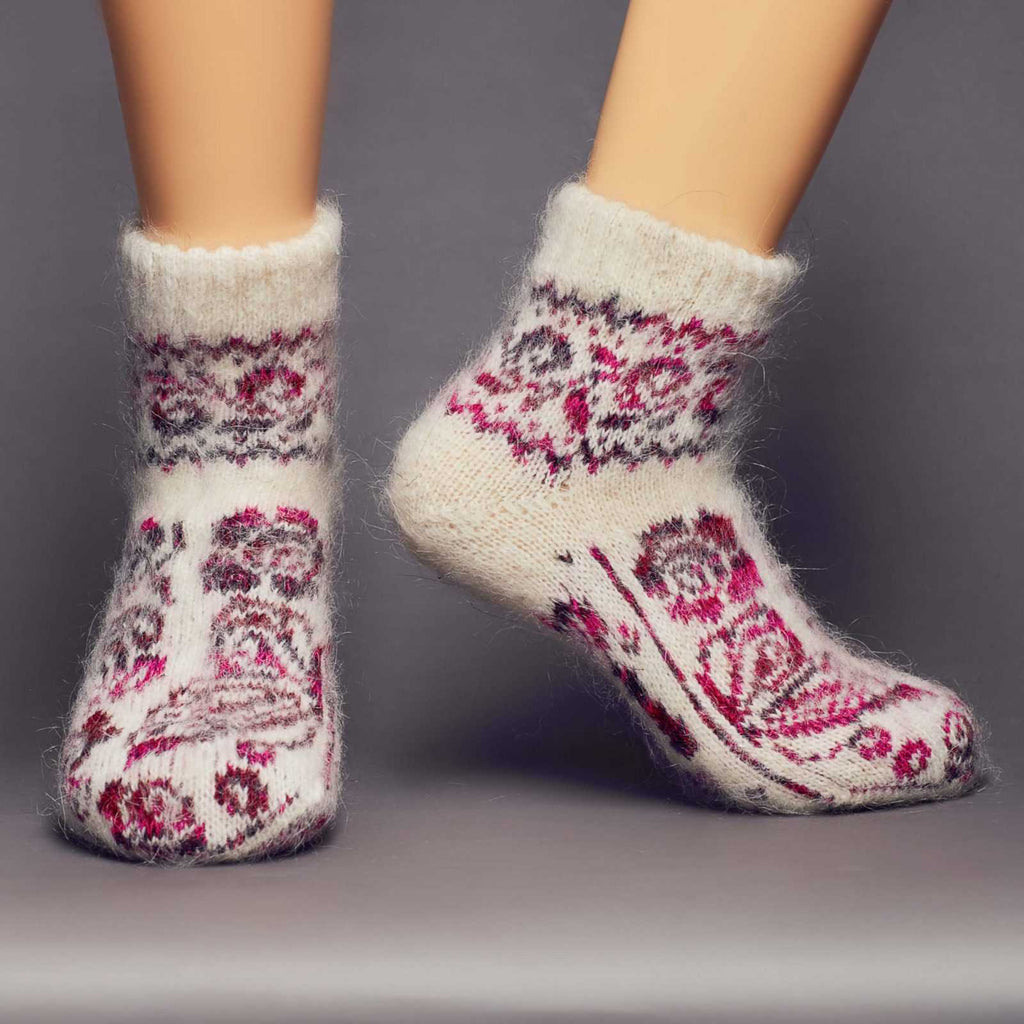 Thick fuzzy goat hair low-cut off-white socks with pink butterflies - front view.