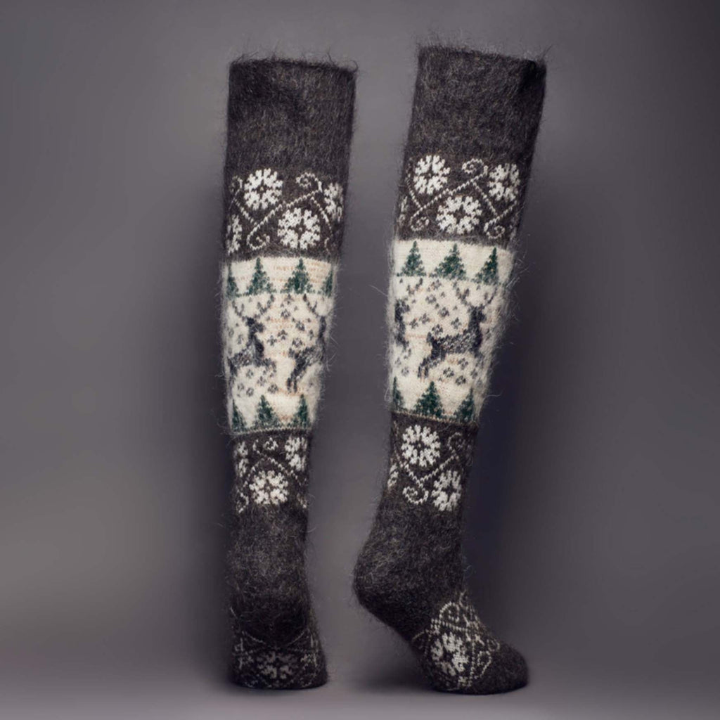 Over-the-knee warm goat wool charcoal and white socks with deer, trees ornaments - back view.