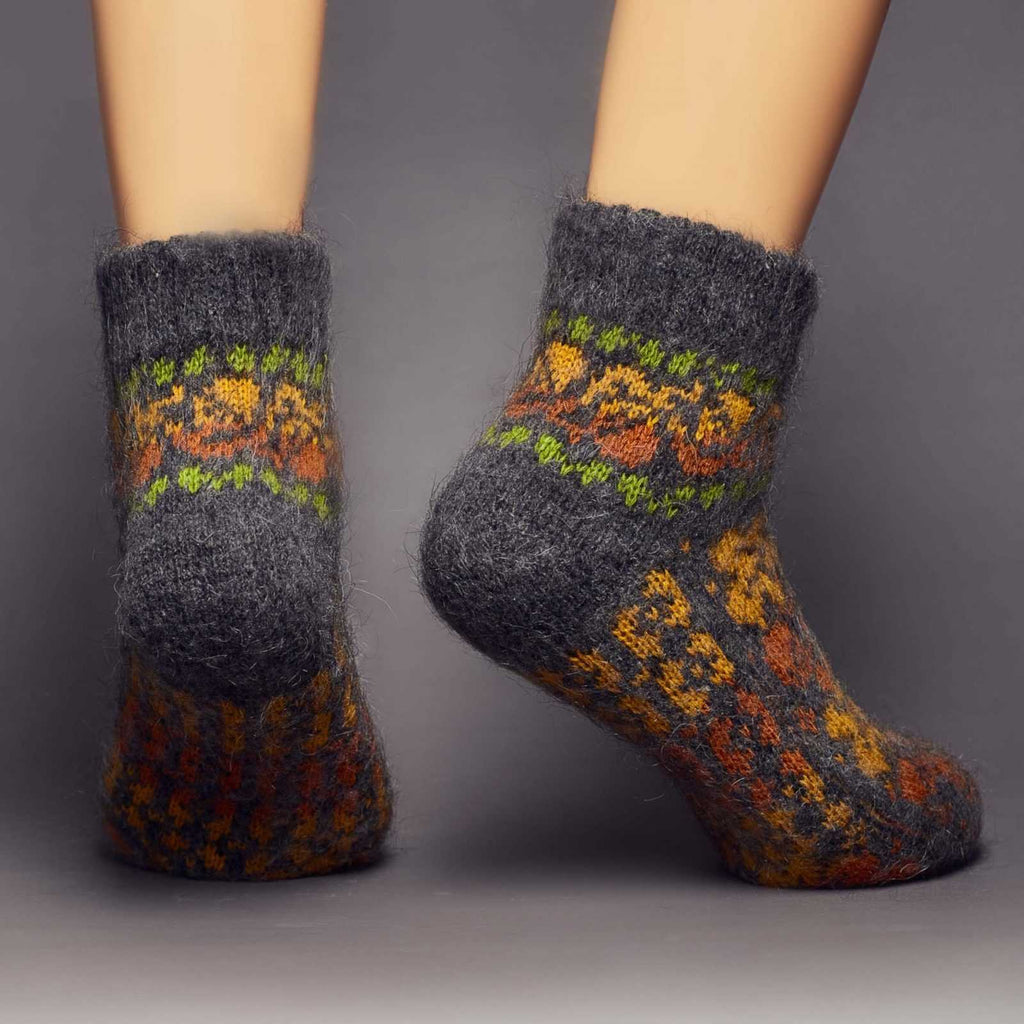 Fuzzy warm goat hair black low-cut socks with yellow-orange fall leaves  - back view.