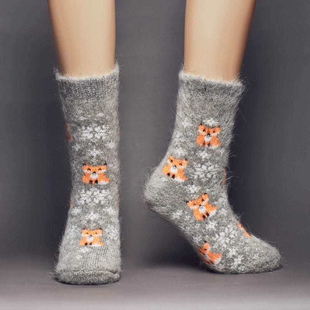 Goat hair warm crew grey socks with orange foxes and white snowflakes - front view.