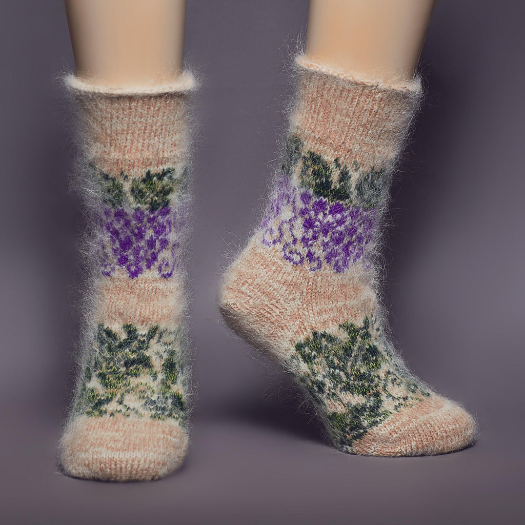 Beige crew goat wool socks with purple, green grapes and leaves design - front view.