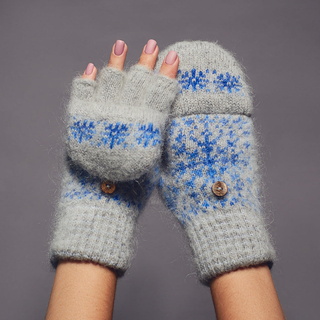 Gray winter fingerless goat wool gloves with a cover with a blue snowflake design.