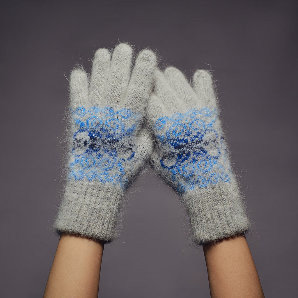 Gray goat hair winter gloves with a multi-blue snowflake design.