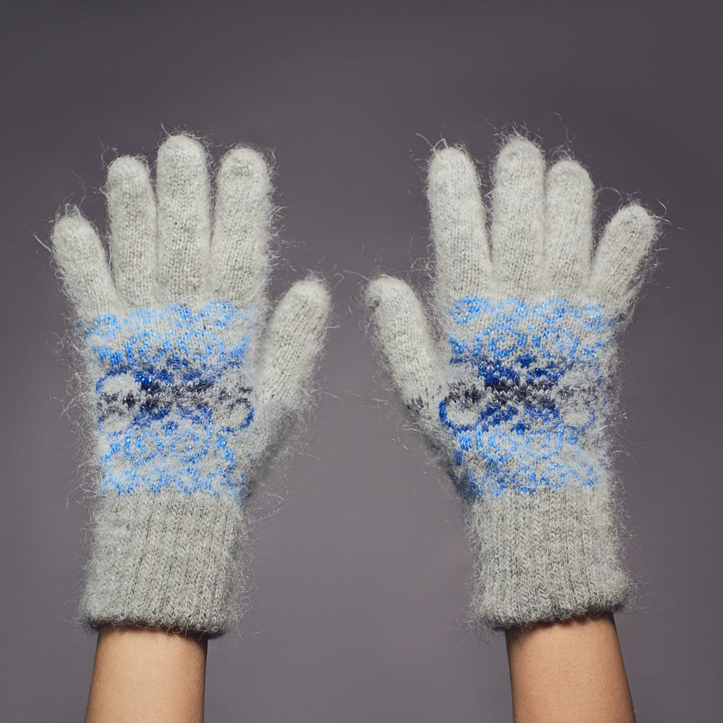 Gray goat hair thick gloves with a multi-blue snowflake design.