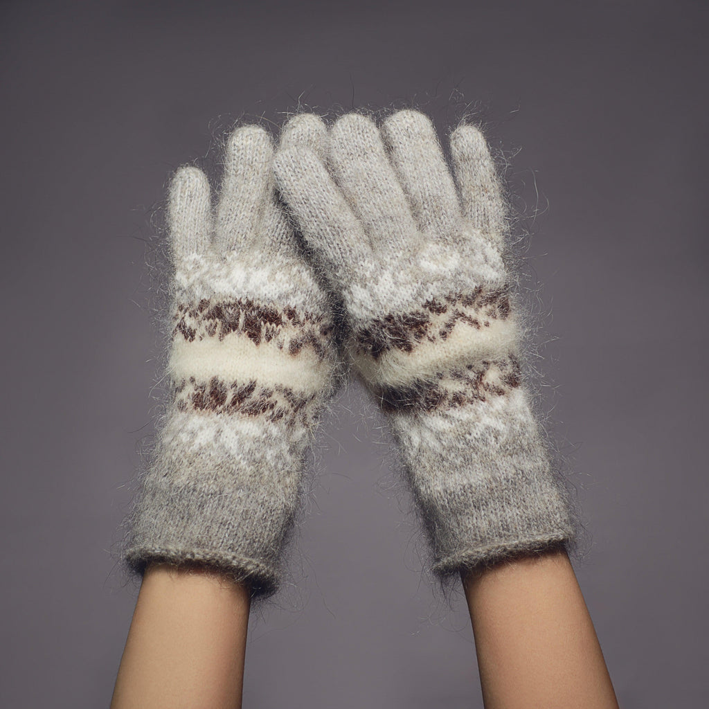 Gray and white goat hair fuzzy, warm gloves with black and white snowflake design.