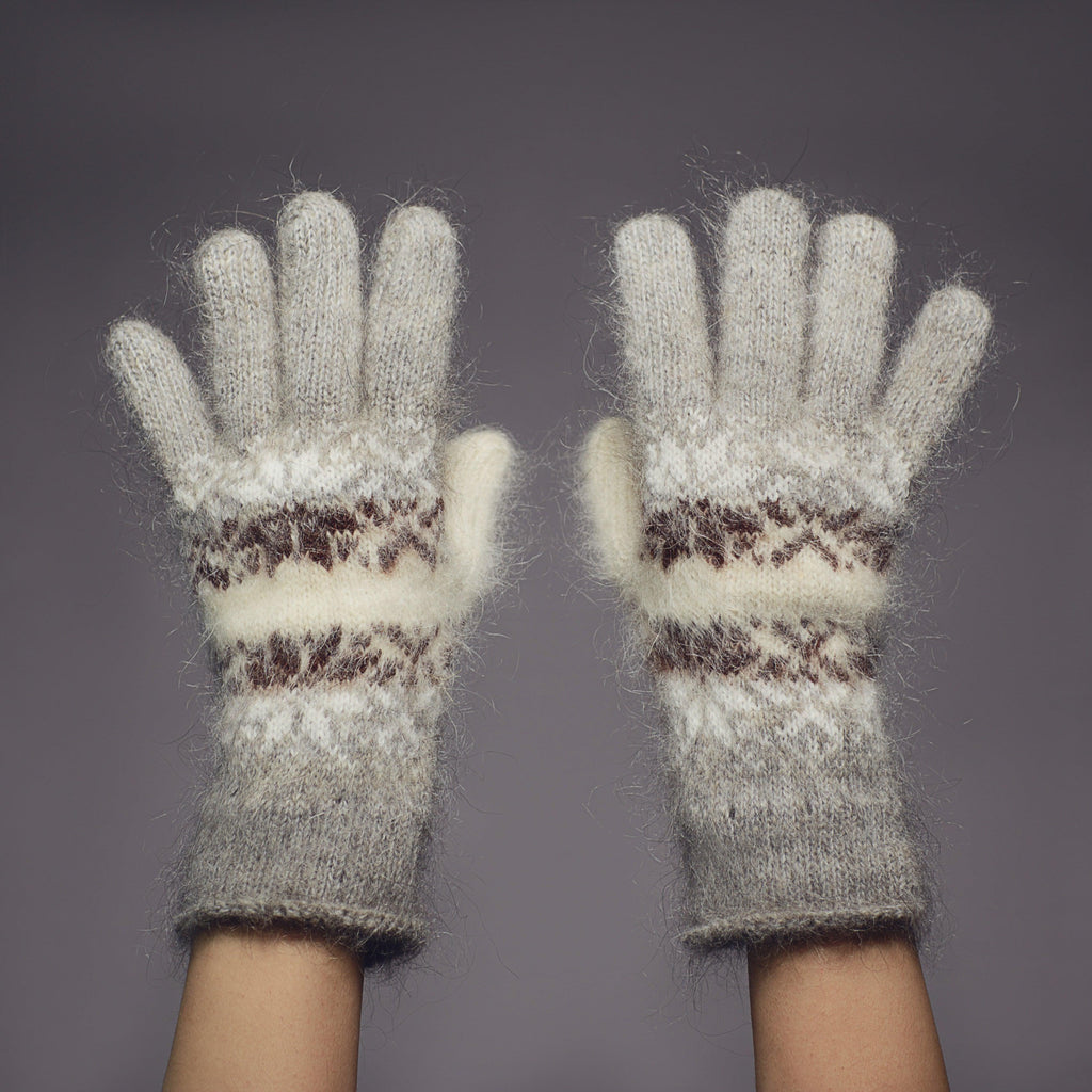 Gray and white goat hair gloves with black and white snowflakes design.