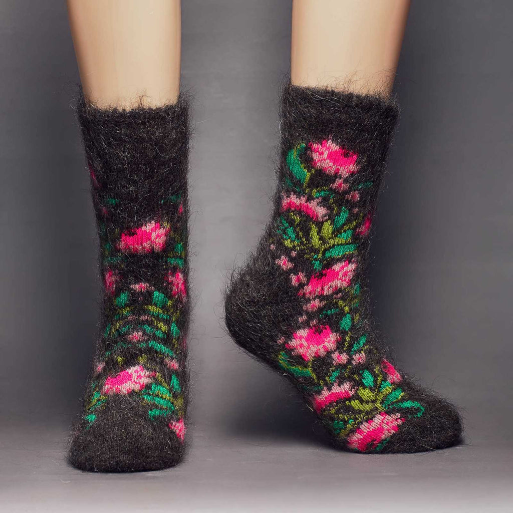 Fuzzy black goat hair thick crew socks with pink flowers and green leaves - front view.