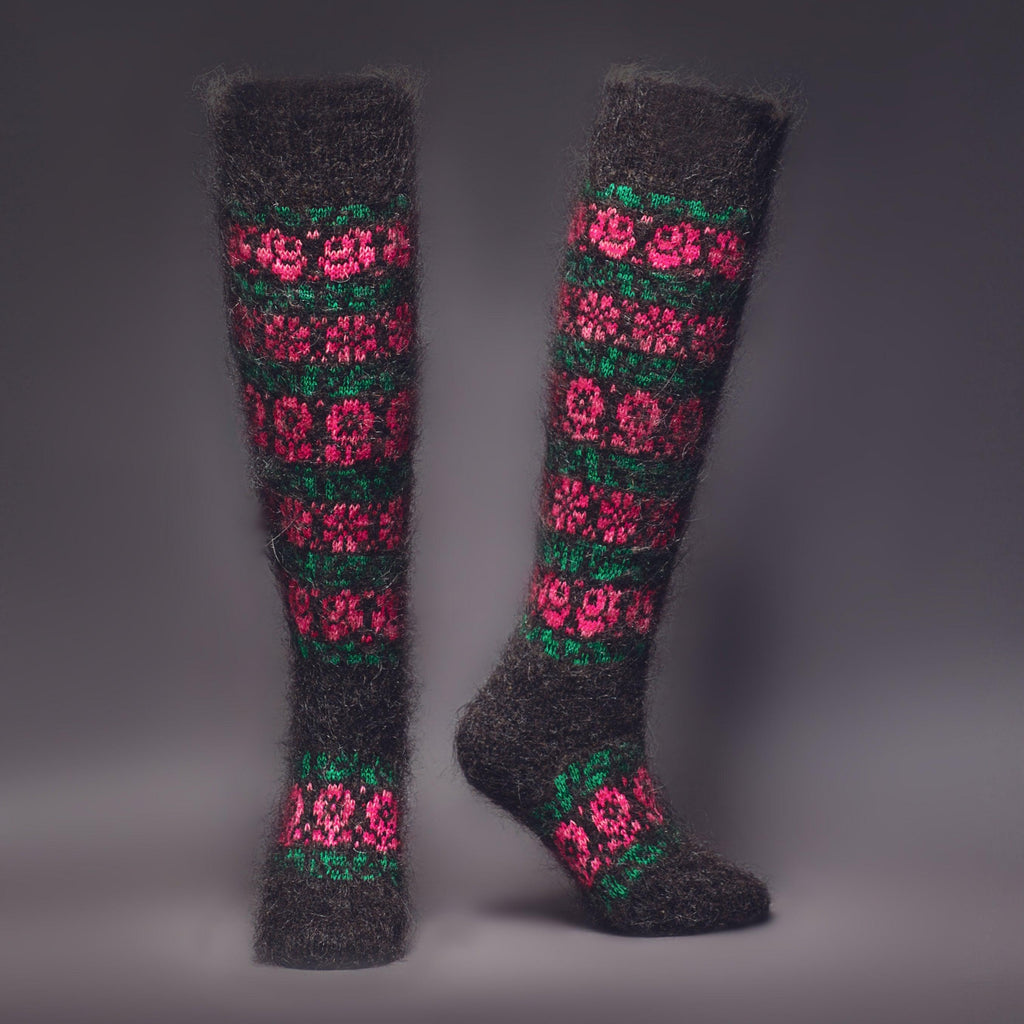 Black knee-high wool socks with a pink and green flower design - front view.