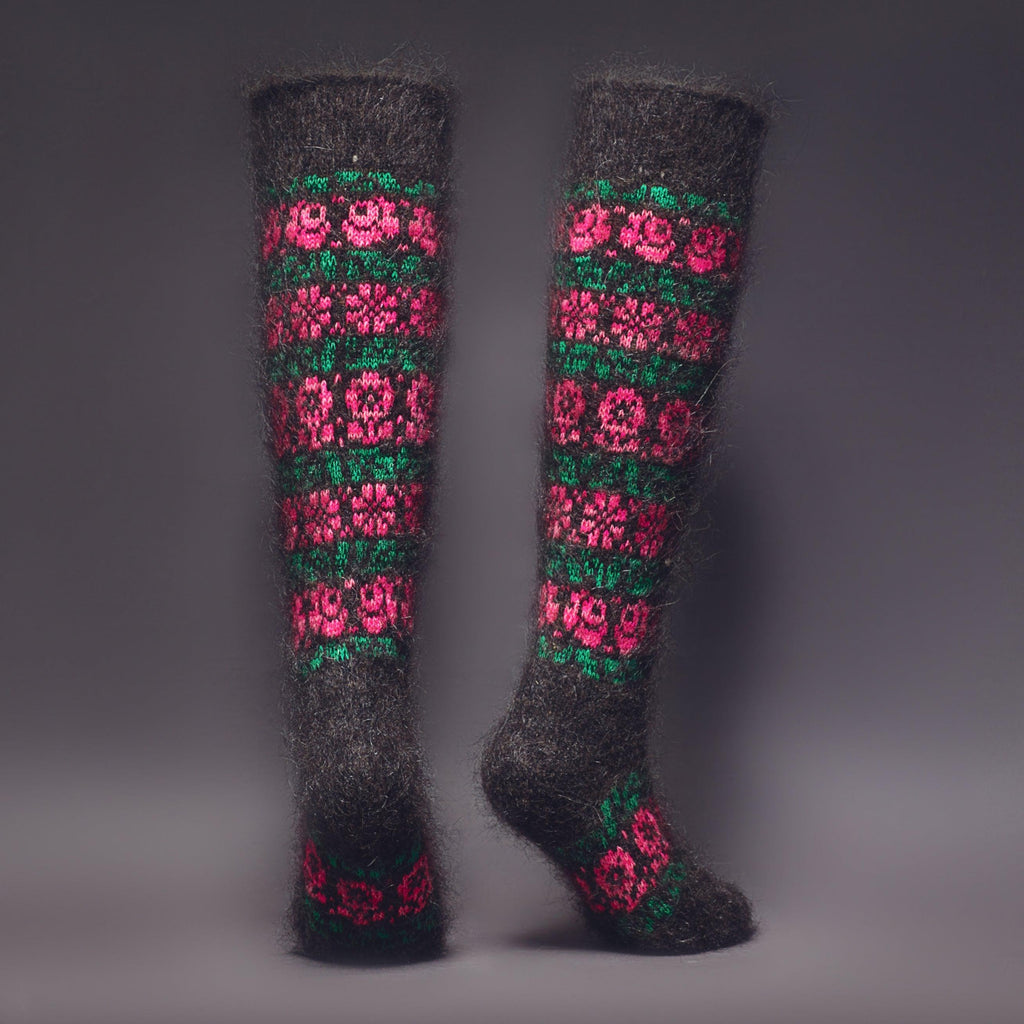 Knee-high black goat hair socks with a pink and green flower pattern - back view.
