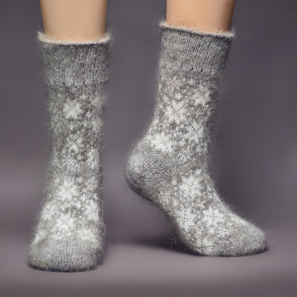 Relaxed fit goat hair grey crew socks with white snowflakes - front view.