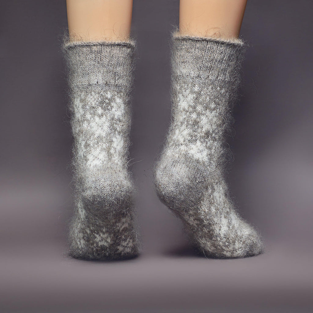 Crew-length grey goat wool socks with no elastic and white snowflake design - back view.