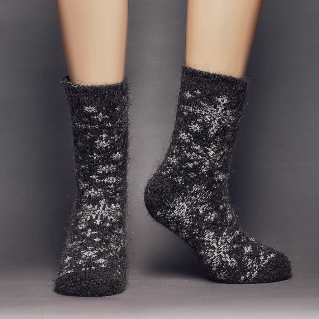 Black goat hair warm socks crew length with snowflake design - front view.