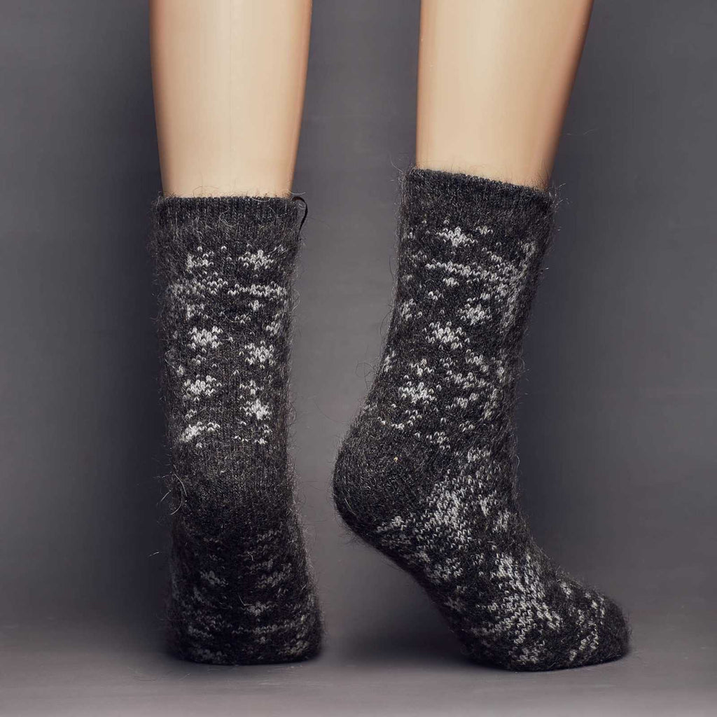 Black goat hair warm socks crew length with snowflake design - back view.