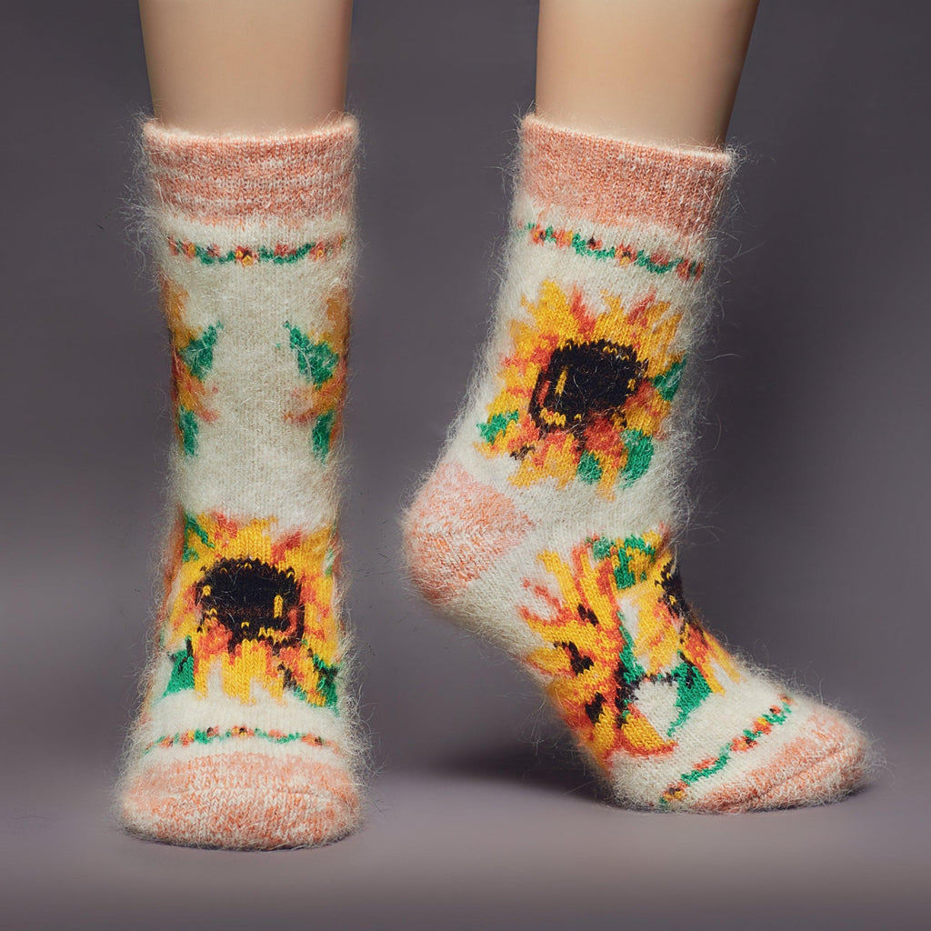 Goat hair white and orange crew socks with sunflower design - front view.