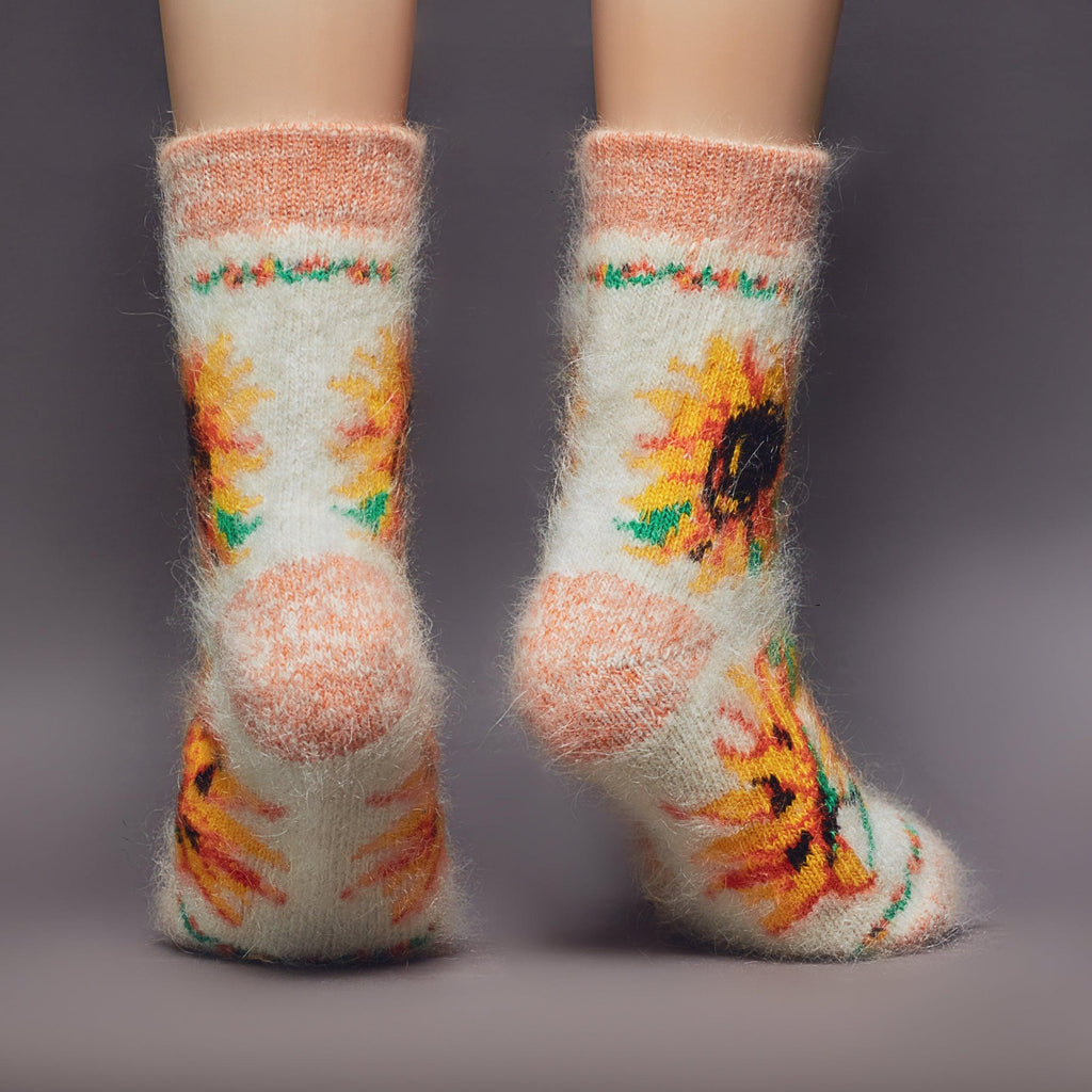 Goat hair white and orange thick socks crew length with sunflower design - back view.
