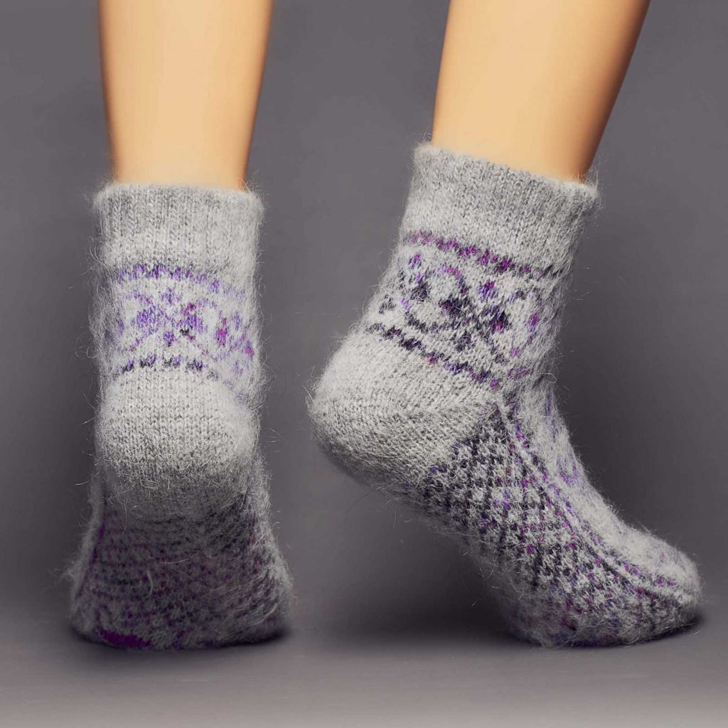Low-cut grey goat wool socks with a purple tulip design - back view.
