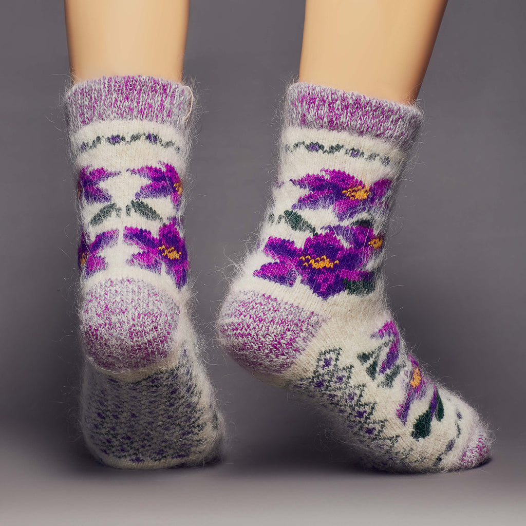 White and purple fuzzy, thick wool socks crew length with violet flower design - back view.