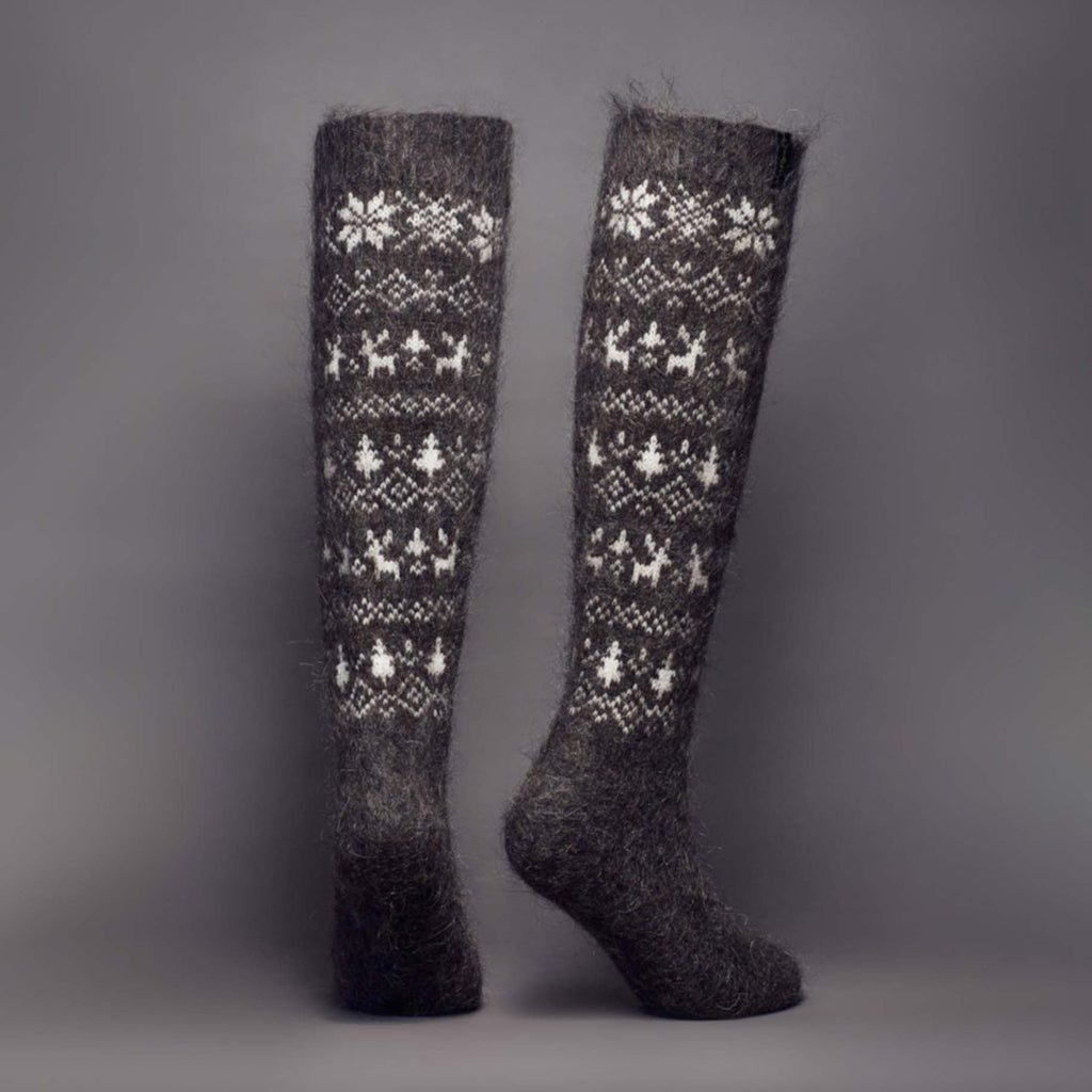 Warm wool knee-high black boot socks with white winter-themed designs - back view.